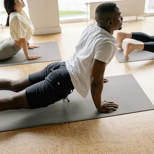 Woman smiling peacefully after a yoga session in a warm lit studio